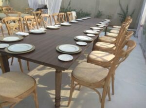 Dining tables and crossback chairs available for rent throughout the UAE for various events.