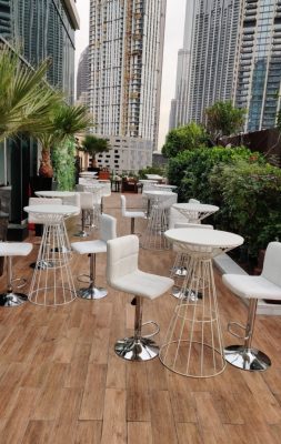 Event furniture rental setup with white wire cocktail table and leather bar stools in Dubai, Abu Dhabi, and UAE.