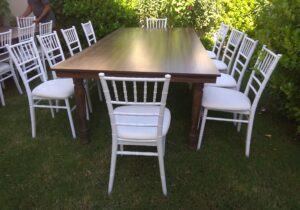 Dark Majestic Dining tables and white Chiavari chairs available for rent throughout the UAE for various events.