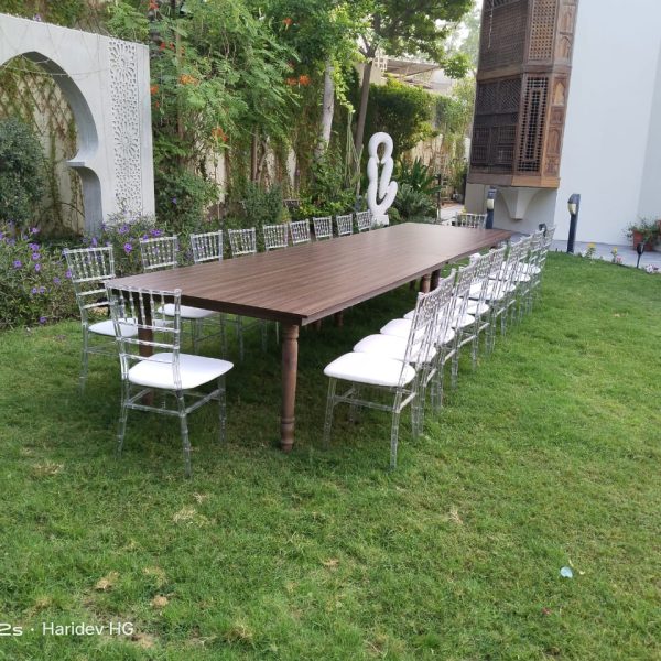 Dining tables and clear acrylic Chiavari chairs available for rent throughout the UAE for various events.