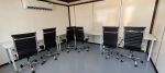 Setup of Niva White Meeting Tables with Black Office Executive Meeting Chairs for Event Rentals in Dubai, Sharjah, Abu Dhabi, Ajman, UAE