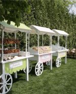 White carts available for rent for setups with snacks, refreshments, desserts, and candy in Dubai, Abu Dhabi, Sharjah, Ajman, and the UAE. Includes options for candy carts, dessert carts, and rustic display carts.