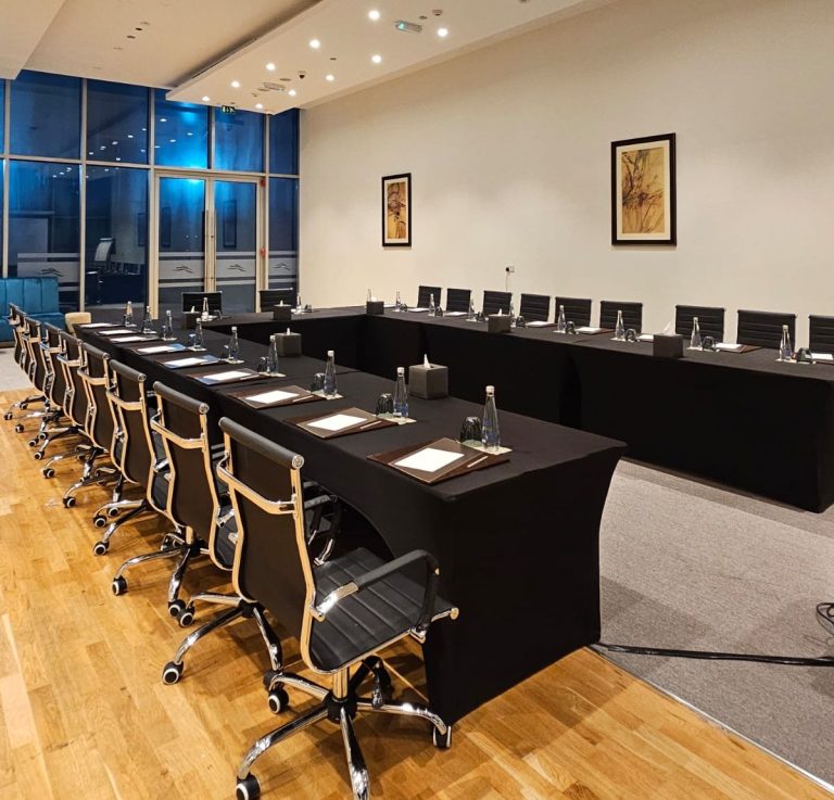 Black Romas Office Chair and Conference table in a professional office setting in Dubai