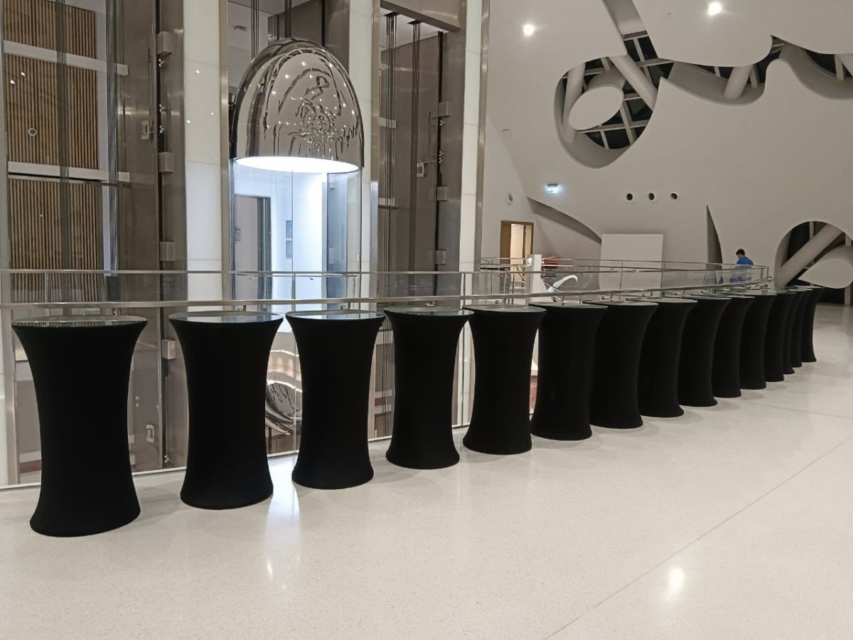 Elegant event setup showcasing the Gloria Cocktail Table with black cover and glass top, offered by Qamar Events for weddings and corporate gatherings in Dubai and across the UAE.