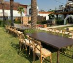 An Image of perfectly well arrange Majestic Dining Table and Crossback Chairs for a wedding reception for dinner purposes furnitures were rented out in Dubai by Qamar Event Rentals