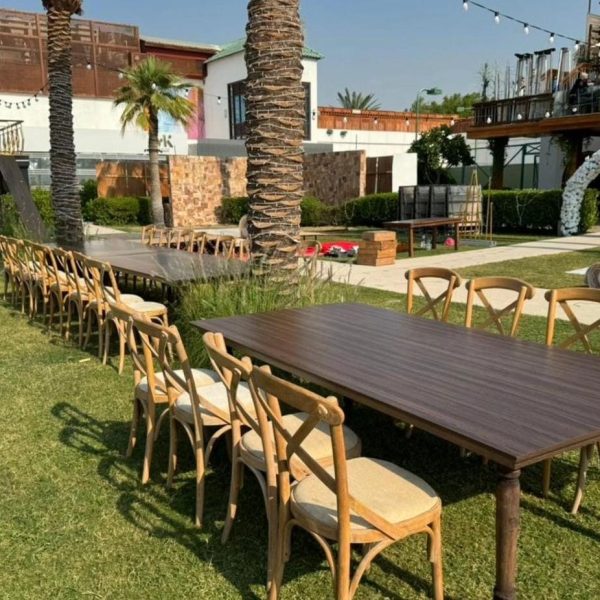 An Image of perfectly well arrange Majestic Dining Table and Crossback Chairs for a wedding reception for dinner purposes furnitures were rented out in Dubai by Qamar Event Rentals