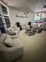 Luxury fabric sofas with wire coffee tables at Abu Dhabi exhibition – Qamar Events rental lounge setup
