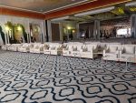 Corporate event setup with rows of fabric sofas and off-white velvet Oslo chairs – Dubai rental furniture
